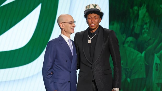 MarJon Beauchamp (G League Ignite) poses with NBA commissioner Adam Silver after being selected as the number twenty-four overall pick by the Milwaukee Bucks in the first round of the 2022 NBA Draft